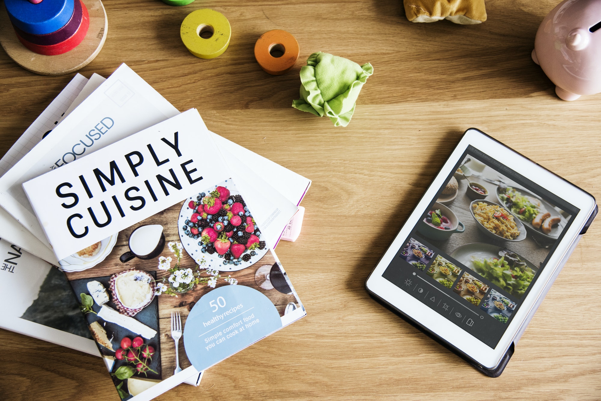 Tablet and magazines on table
